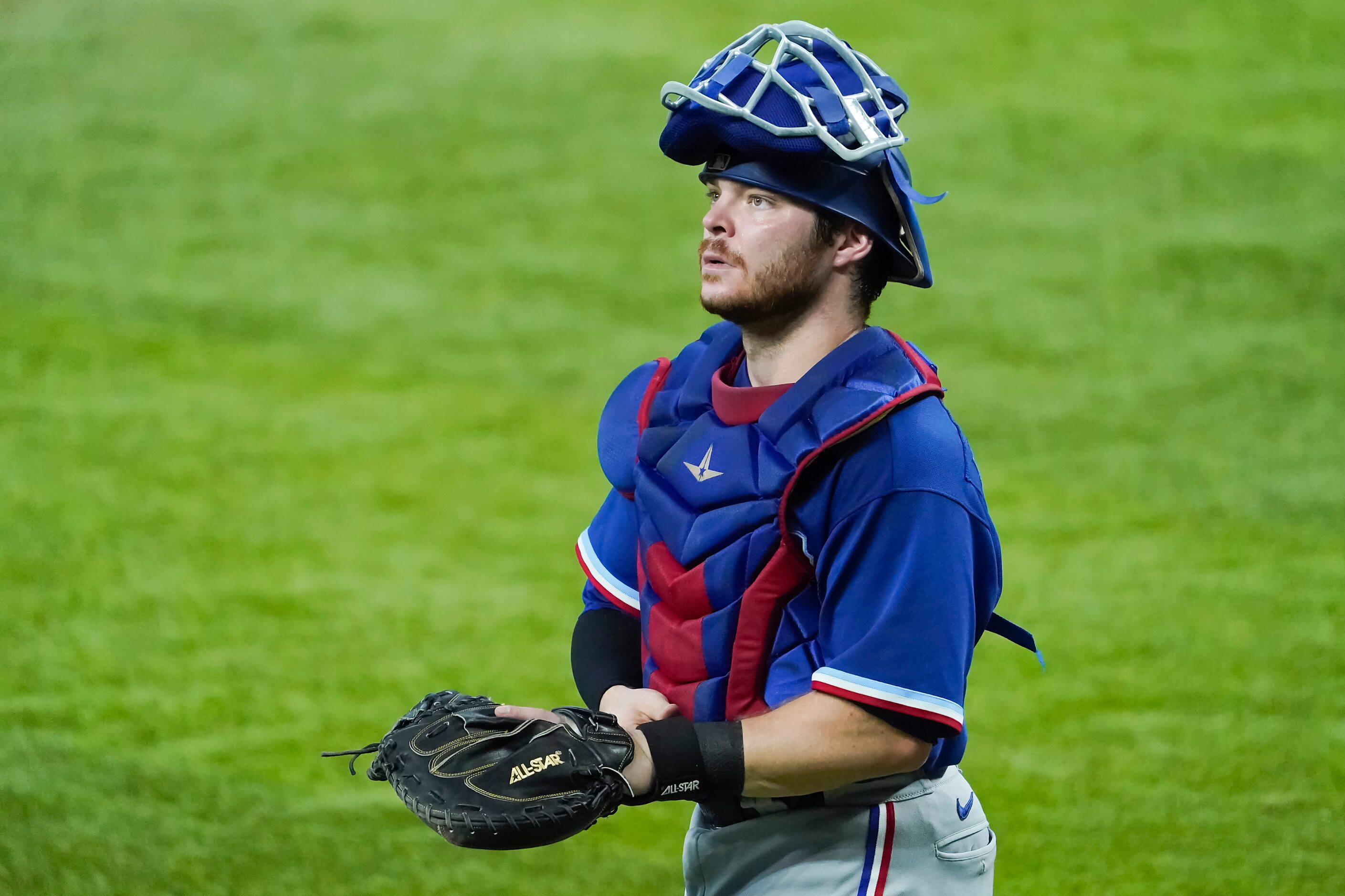 Texas Rangers catcher Matt Whatley looks out on the stadium during a game between players at...