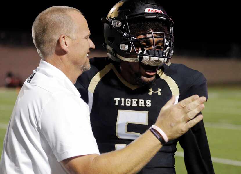 Mansfield coach Daniel Maberry celebrates with senior defensive back Cam'ron Jones during a...