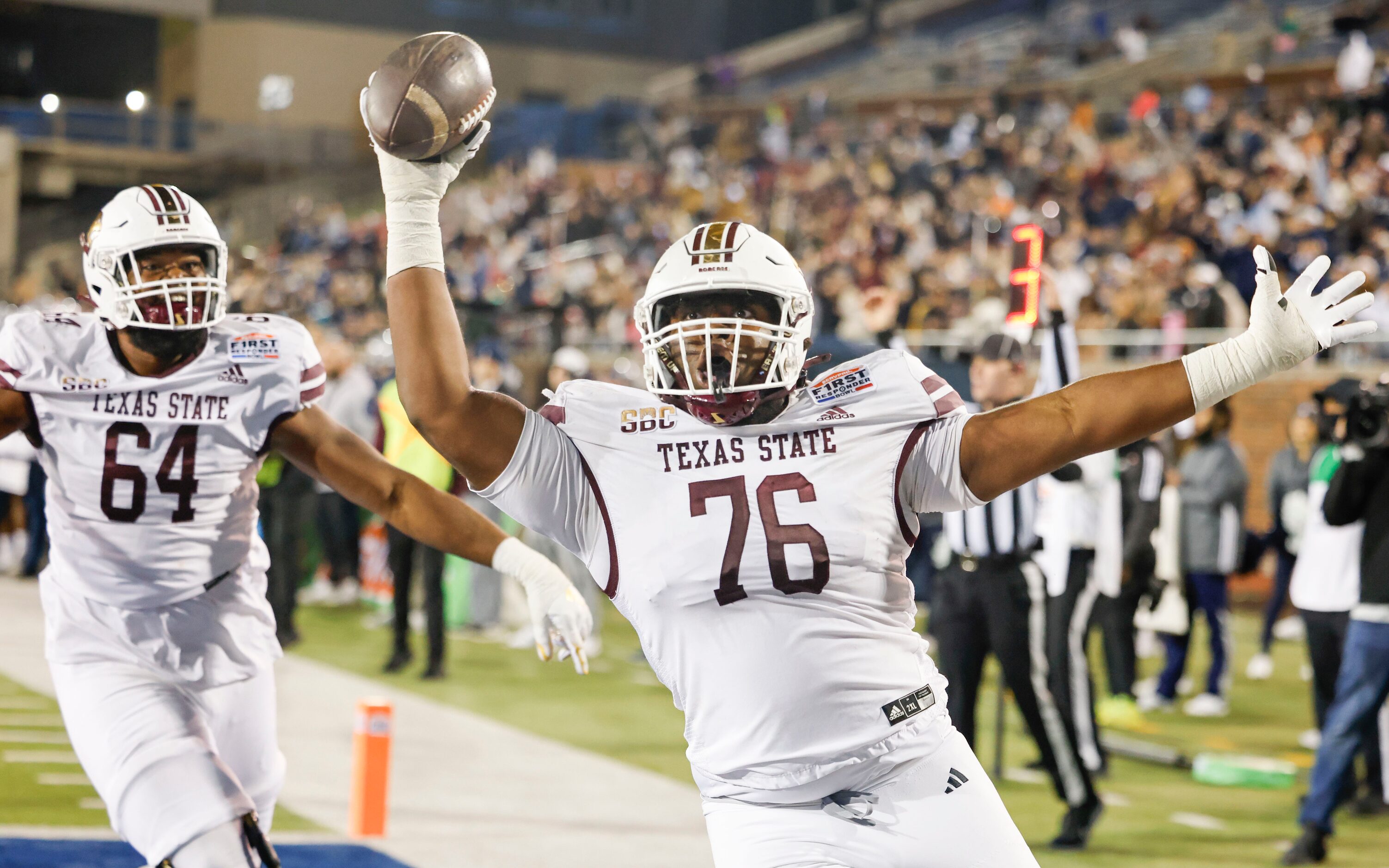 Texas State offensive lineman Nash Jones (76) celebrates a touchdown with his teamate Texas...