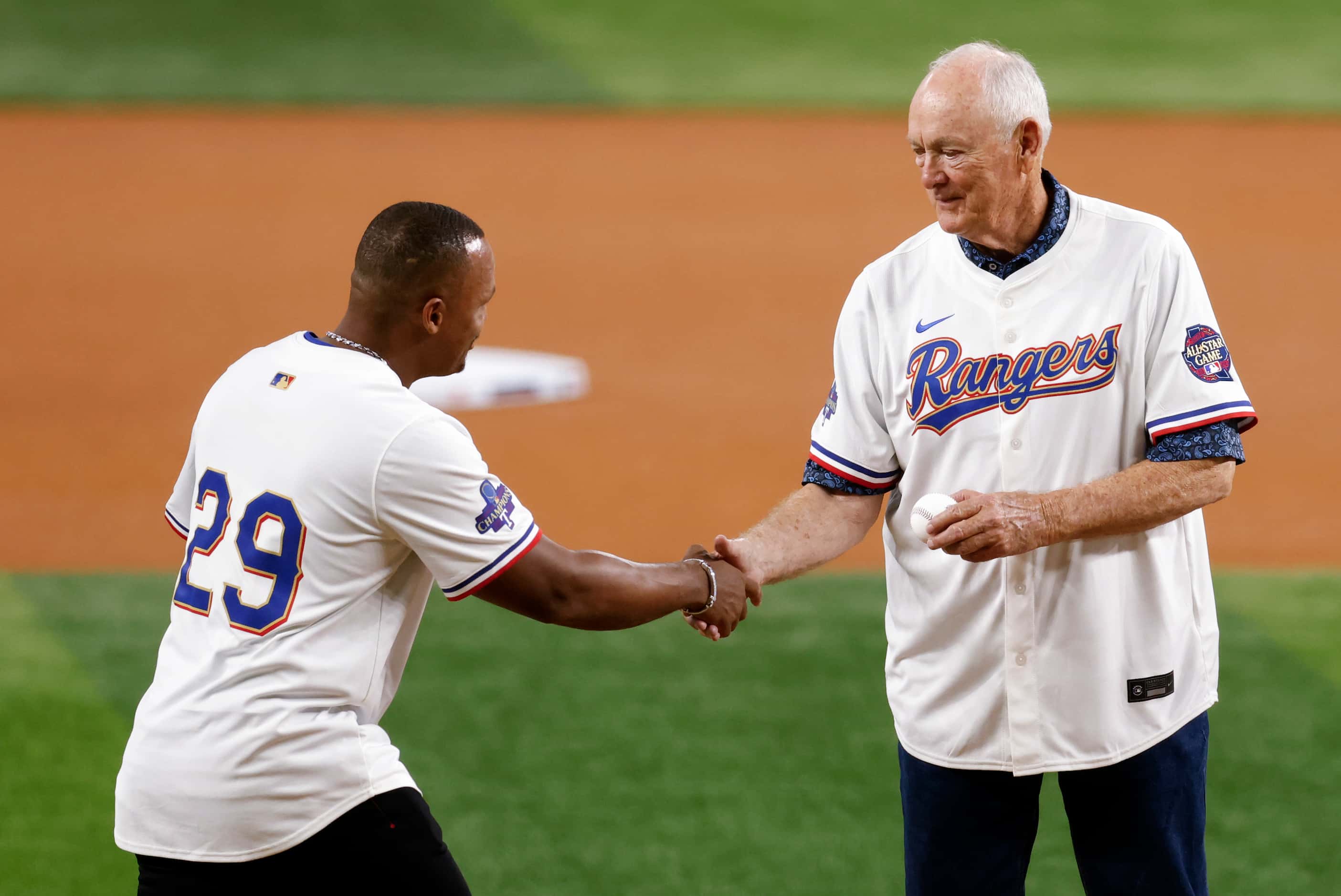 Former Texas Rangers third baseman Adrian Beltre shakes hands with Hall of Famer Nolan Ryan...