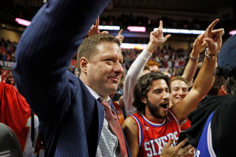 Texas Tech coach Chris Beard celebrates on the court with fans after the team's NCAA college...