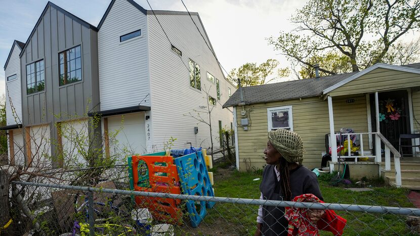 In this photo from March 2023, Pearlie Mae Brown pauses while collecting her washing in...