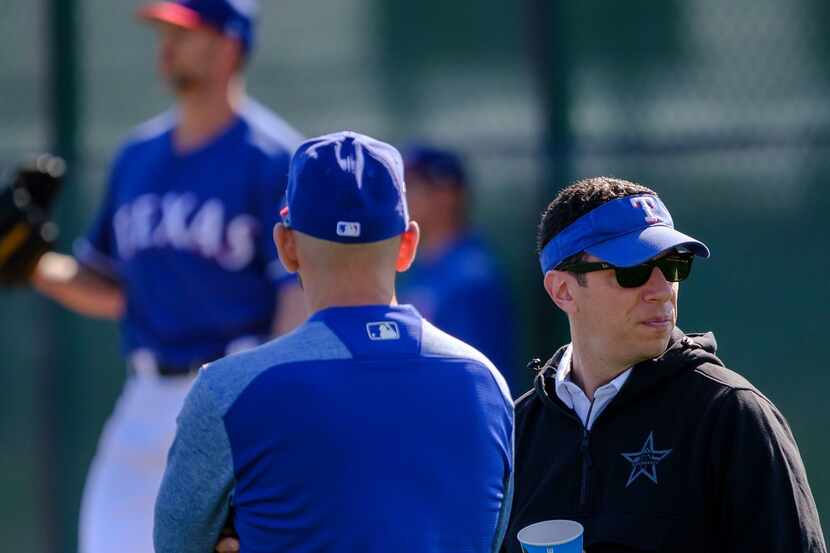 Texas Rangers general manager Jon Daniels (right) watches a bullpen session with manager...