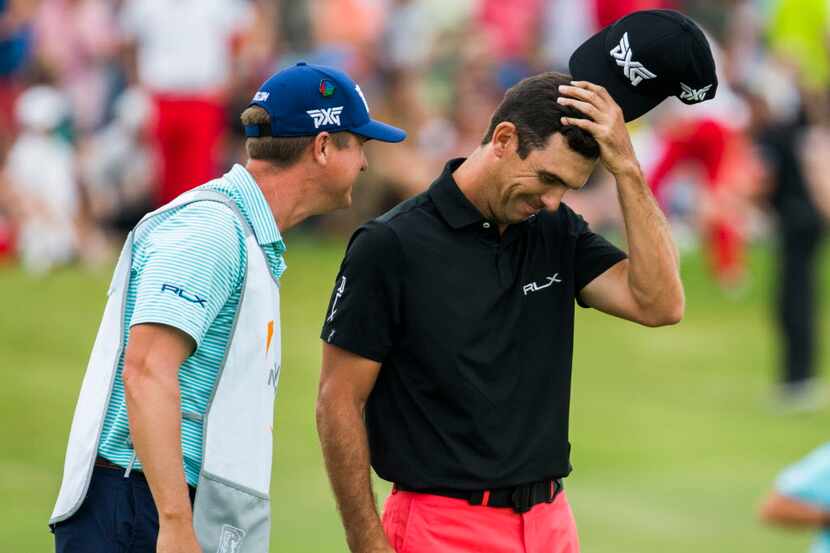 Billy Horschel and his caddie, Josh Cassell, react after Jason Day missed a putt on the 18th...