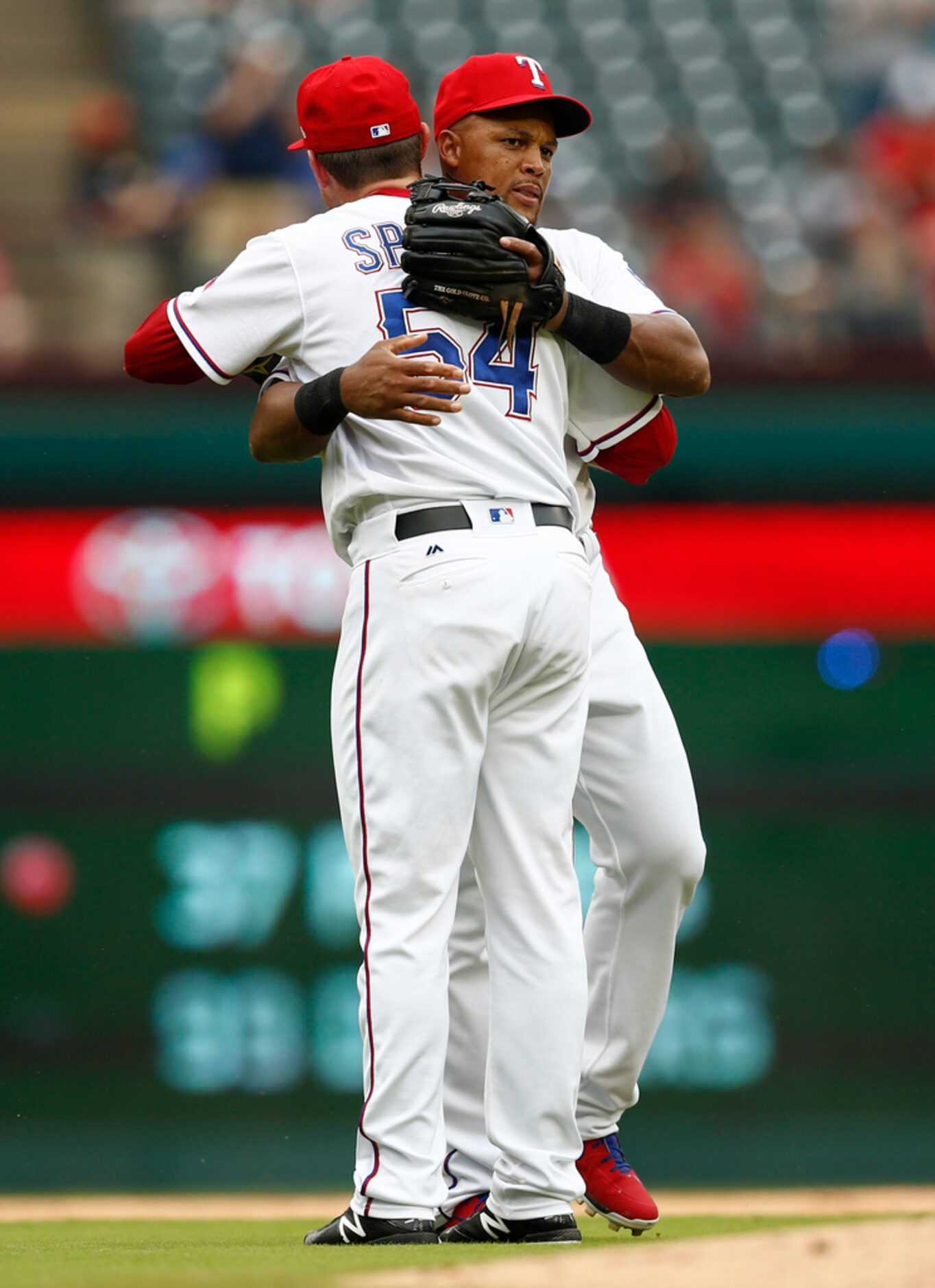 Texas Rangers' Adrian Beltre, right, embraces relief pitcher Jeffrey Springs (54) after...