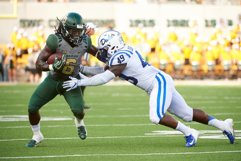 WACO, TX - SEPTEMBER 15:  Jamycal Hasty #6 of the Baylor Bears is wrapped up by Koby Quansah...