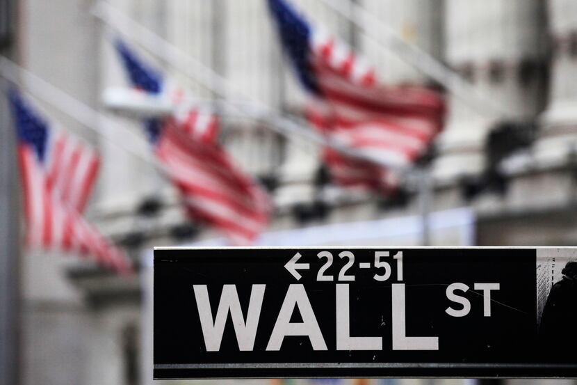 FILE - This April 22, 2010, file photo, shows a Wall Street sign in front of the New York...