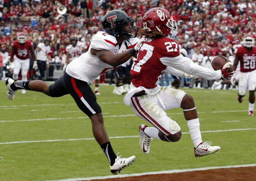 Oklahoma cornerback Dakota Austin (27) intercepts a pass intended for Texas Tech wide...