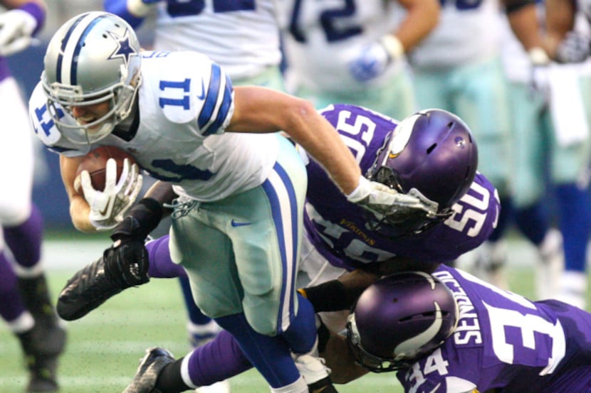 Cowboys wide receiver Cole Beasley is chased by Vikings linebacker Erin Henderson and safety...