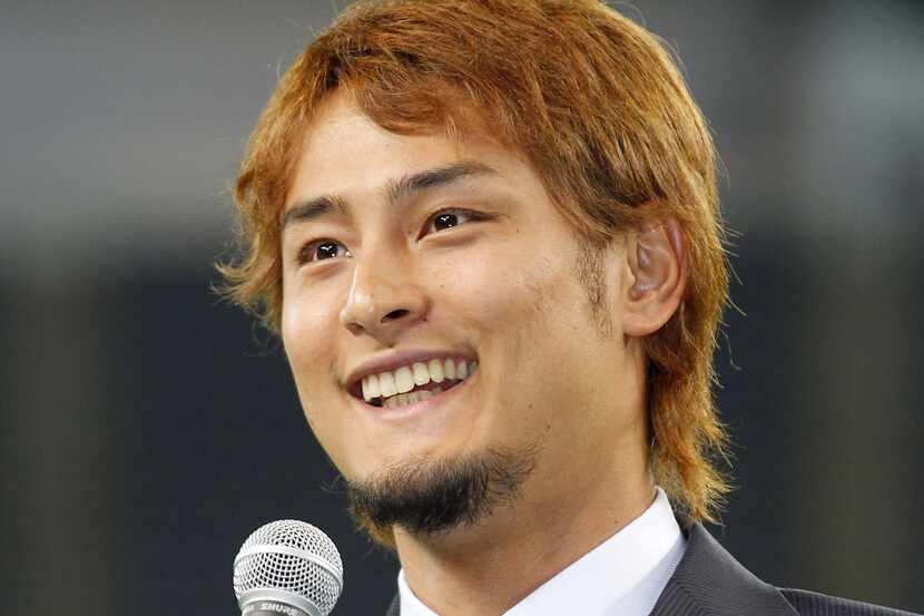 Japanese pitcher Yu Darvish, who'll play for the Texas Rangers next season, speaks to his...