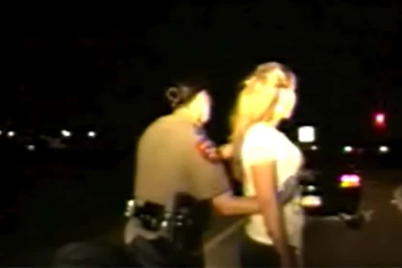 Texas Department of Public Safety trooper Kelly Helleson frisks a woman during a July 13...