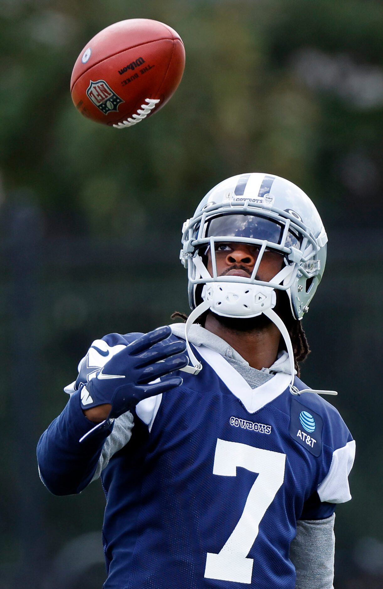 Dallas Cowboys cornerback Trevon Diggs (7) tosses the football before training camp practice...