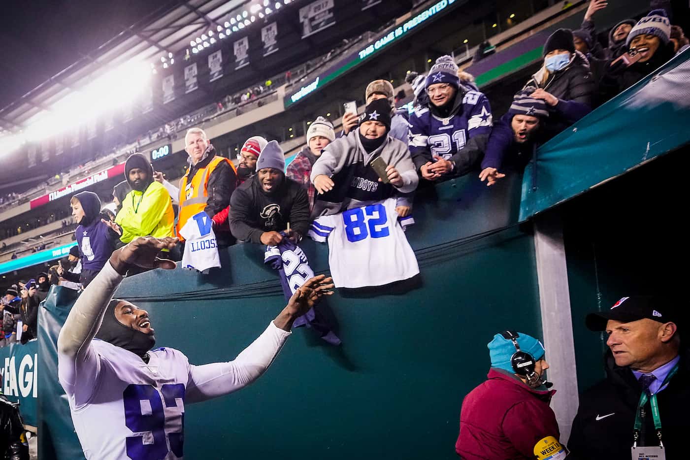 Dallas Cowboys defensive end Tarell Basham (93) celebrates with fans as he leaves the field...