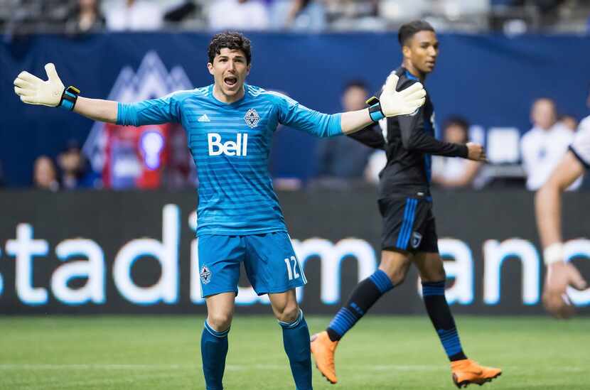 Vancouver Whitecaps goalkeeper Brian Rowe, front, reacts after San Jose Earthquakes' Danny...