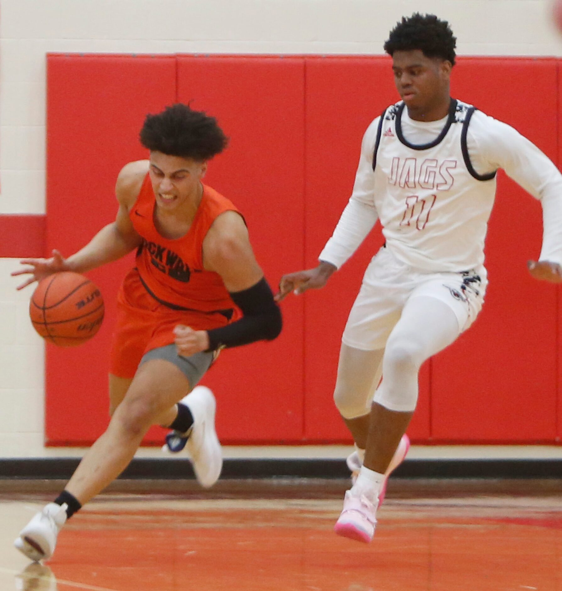 Rockwell's Will Bartoszek (20) pulls down a rebound and dribbles away from the defensive...