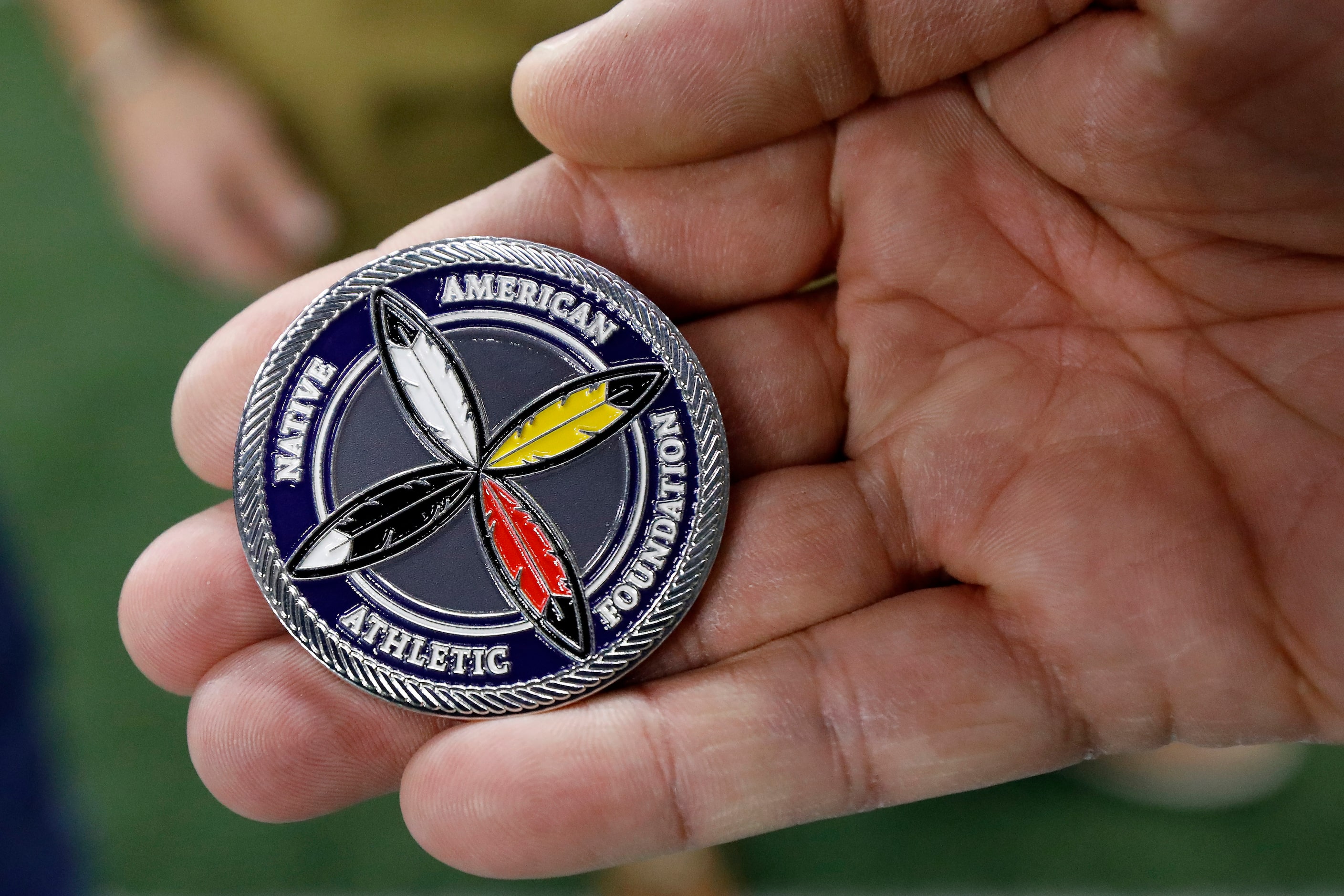 The heads side of the Native American All-Star Football Game ceremonial coin at the Ford...