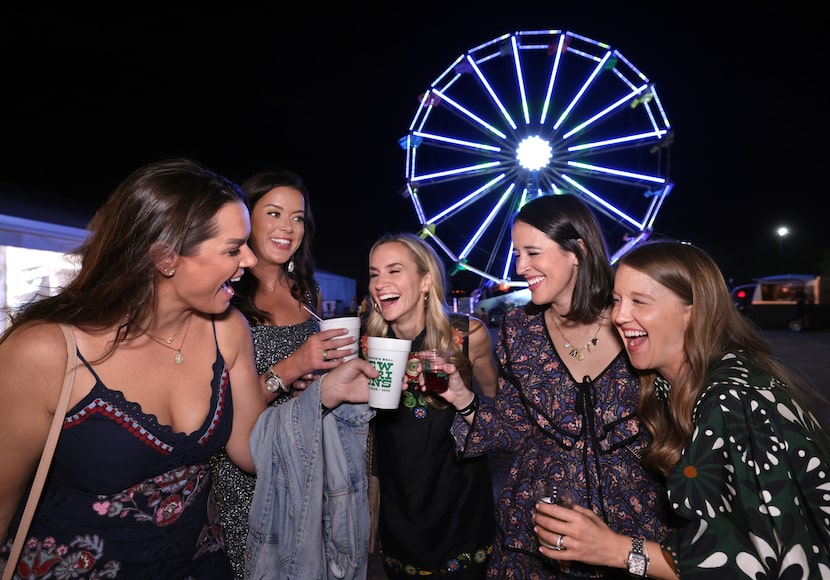 Guests enjoy drinks on the grounds of Southfork Ranch at the Cattle Baron's Ball in Parker,...