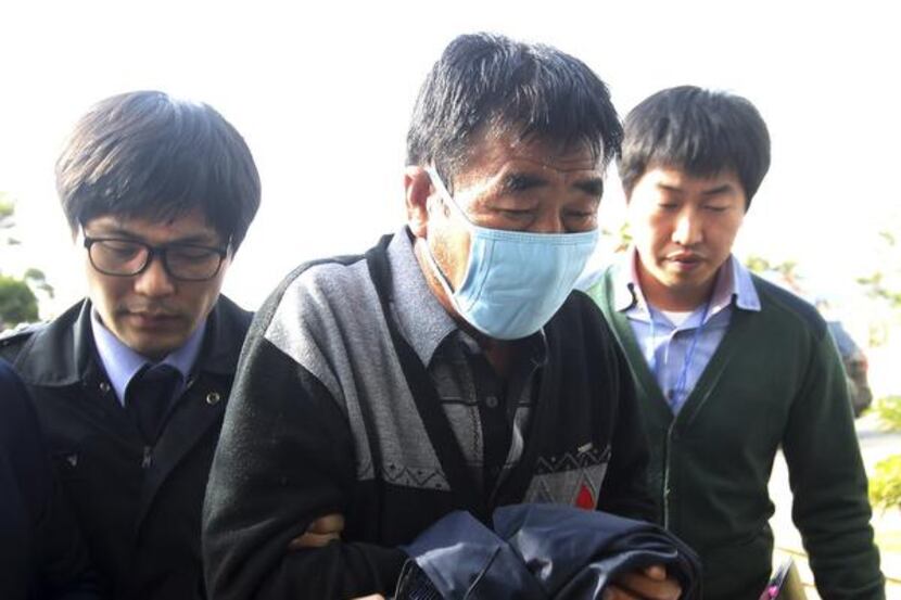 
Lee Joon-seok (center), the captain who abandoned his sinking ferry off South Korea, was...