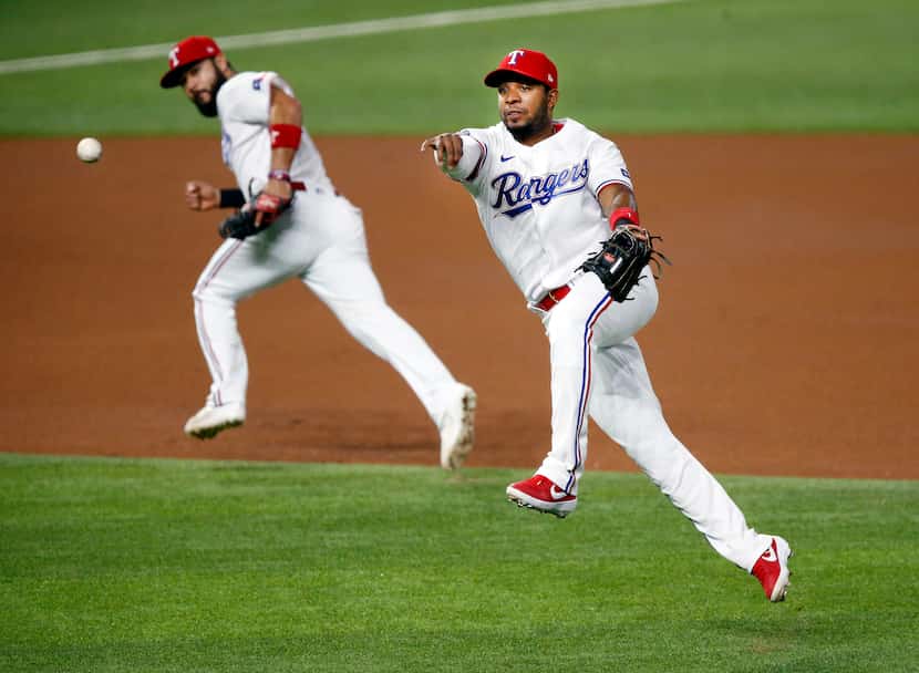 Texas Rangers shortstop Elvis Andrus (1) whips the ball to first in hopes of getting Seattle...