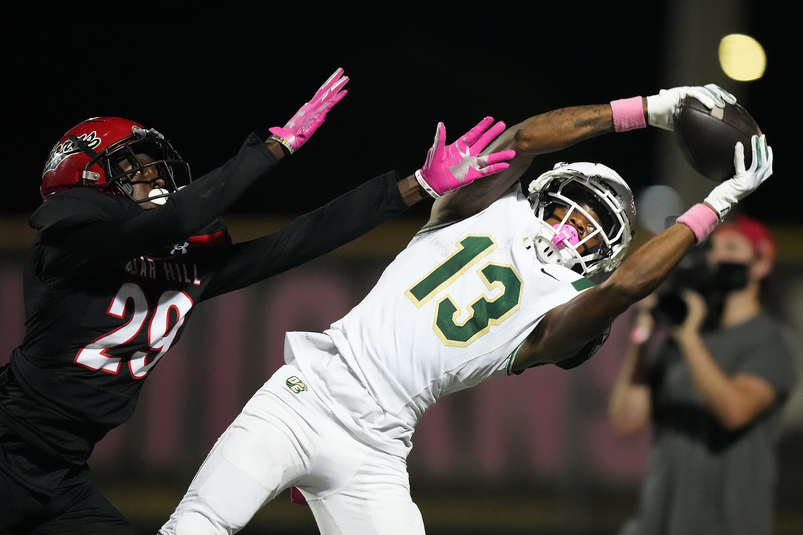 DeSoto wide receiver Daylon Singleton (13) catches a pass as Cedar Hill defensive back...