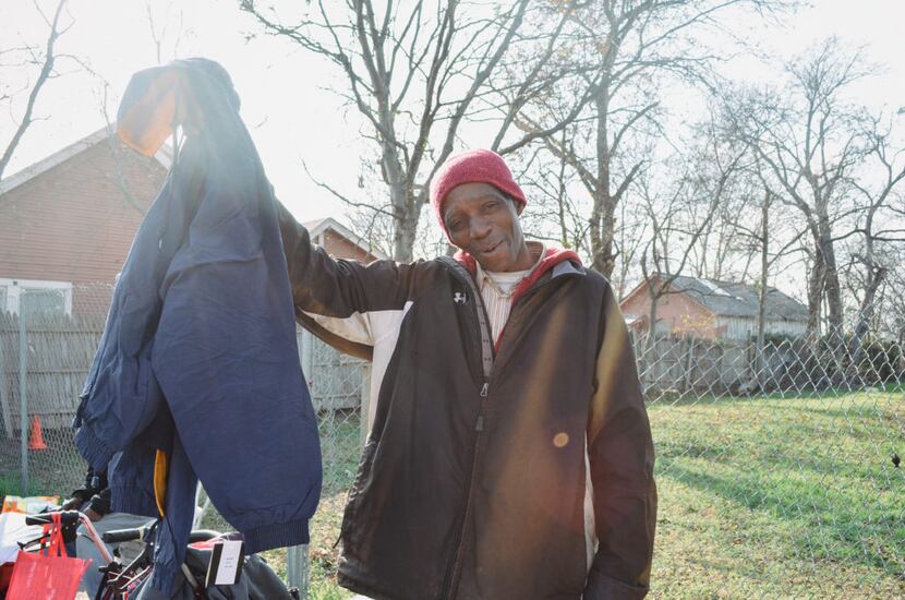 Homeless man receiving a coat