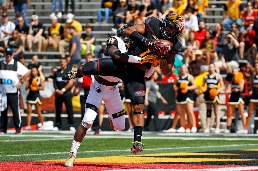 FILE - Maryland wide receiver D.J. Moore (1) catches a touchdown pass in front of Towson...