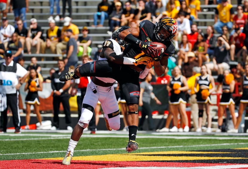 FILE - Maryland wide receiver D.J. Moore (1) catches a touchdown pass in front of Towson...
