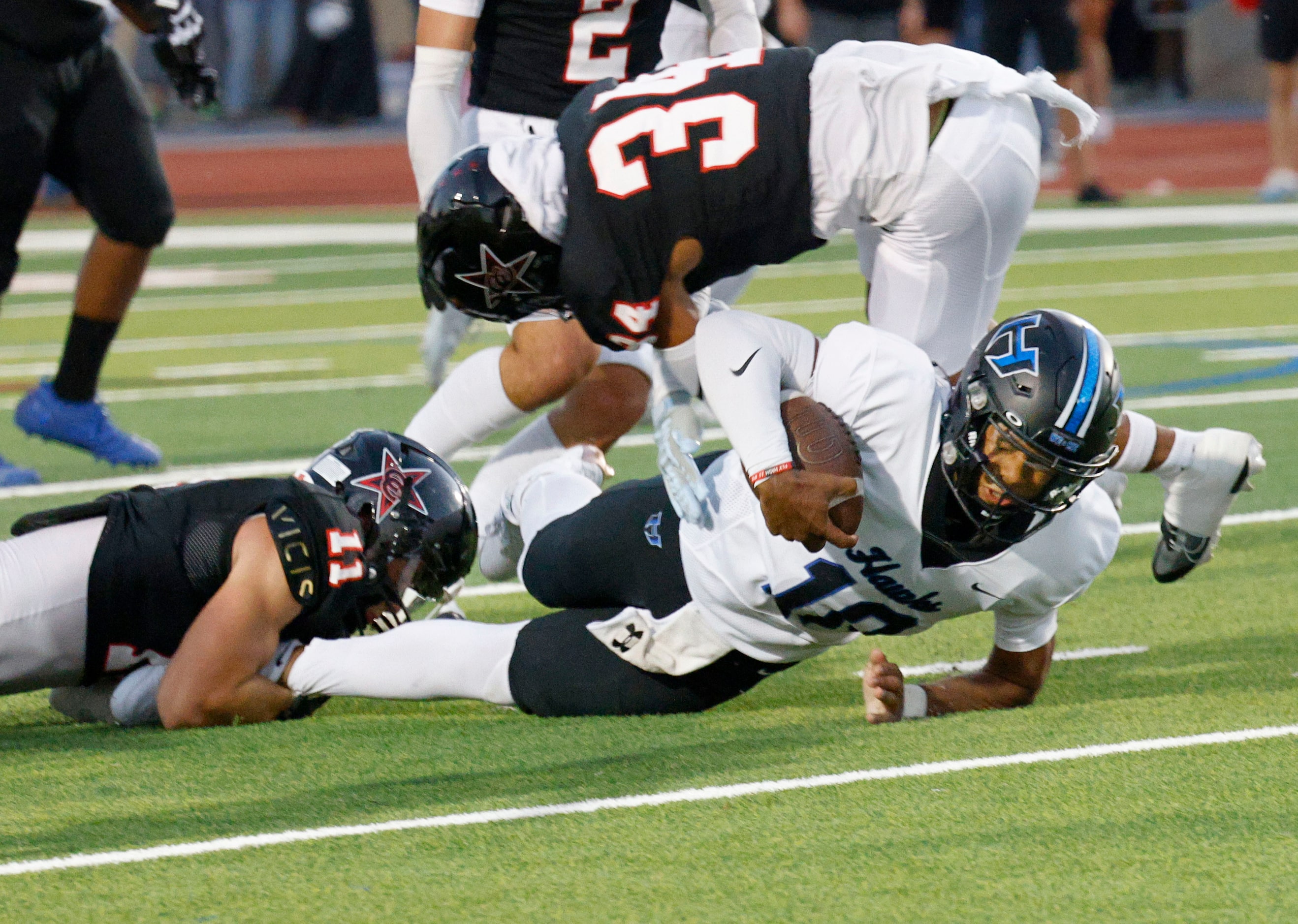 Hebron's quarterback Patrick Crayton Jr. (10) is tackled by Coppell's Weston Polk (11) and...