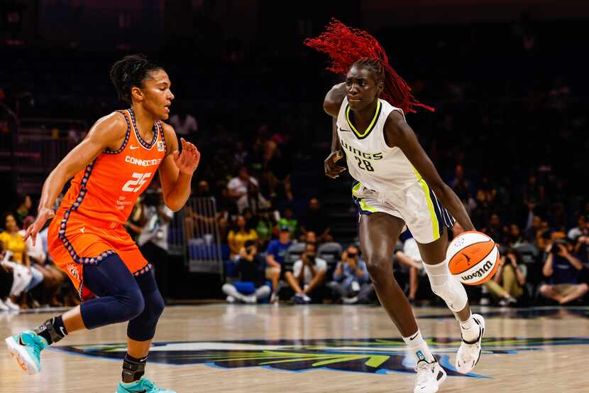 Dallas Wings center Awak Kuier (28) moves the ball around Connecticut Sun forward Alyssa...