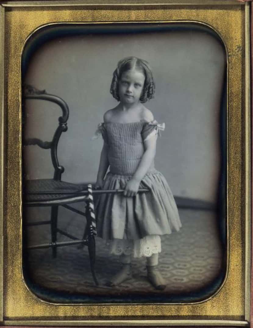 
A half-plate daguerreotype depicts a girl with a hoop and stick by Marcus Aurelius Root...