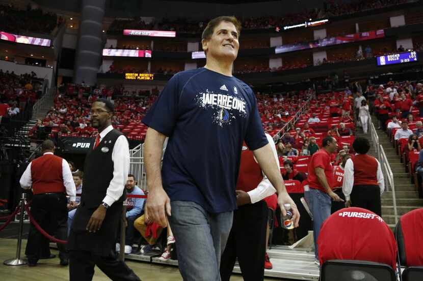 Dallas Mavericks owner Mark Cuban makes his way onto the court before a game against the...