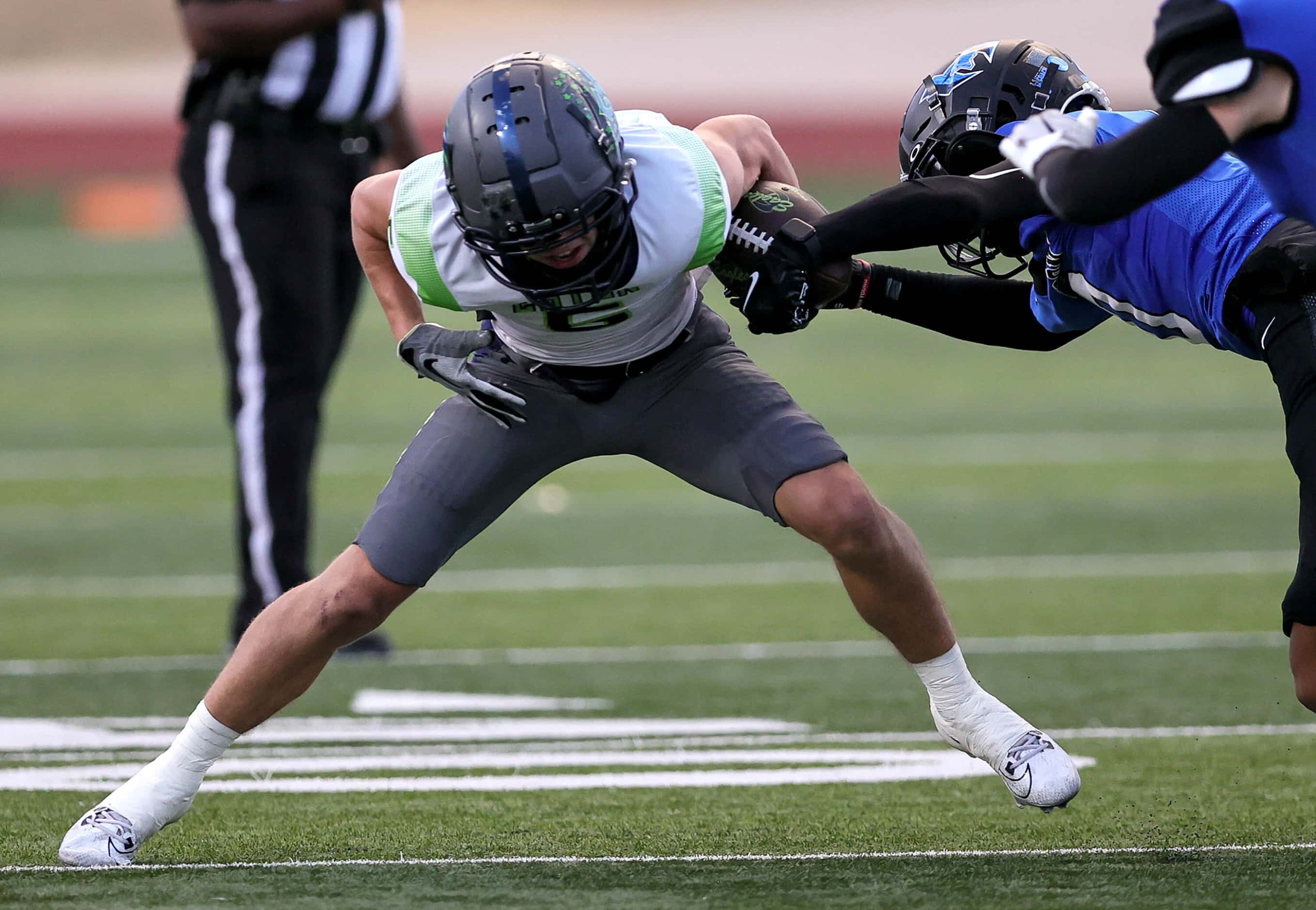 Eaton wide receiver Mason Stubbe (5) avoids getting the ball stripped by Hebron defensive...