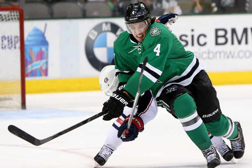 Dallas Stars defenseman Brenden Dillon (4) battles with Columbus Blue Jackets right wing Cam...