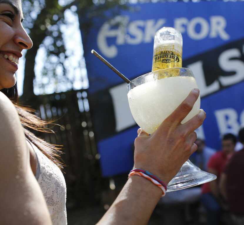 Tatiana Cuell holds a beer-garita" -- a margarita with a mini Corona in it -- at Katy Trail...