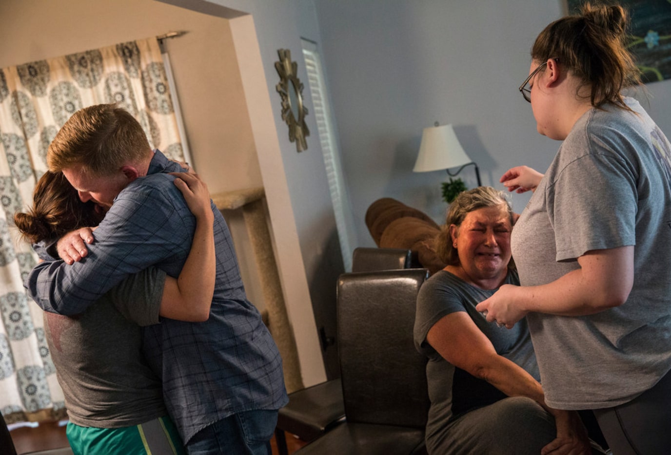 Tamara Steel, left, hugs her stepfather Paul Clyde while Kristina Shannon, right, embraces...