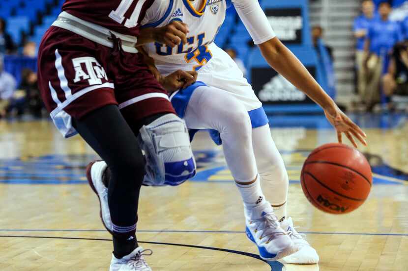 UCLA guard Jordin Canada, right, drives against Texas A&M guard Aahliyah Jackson during the...