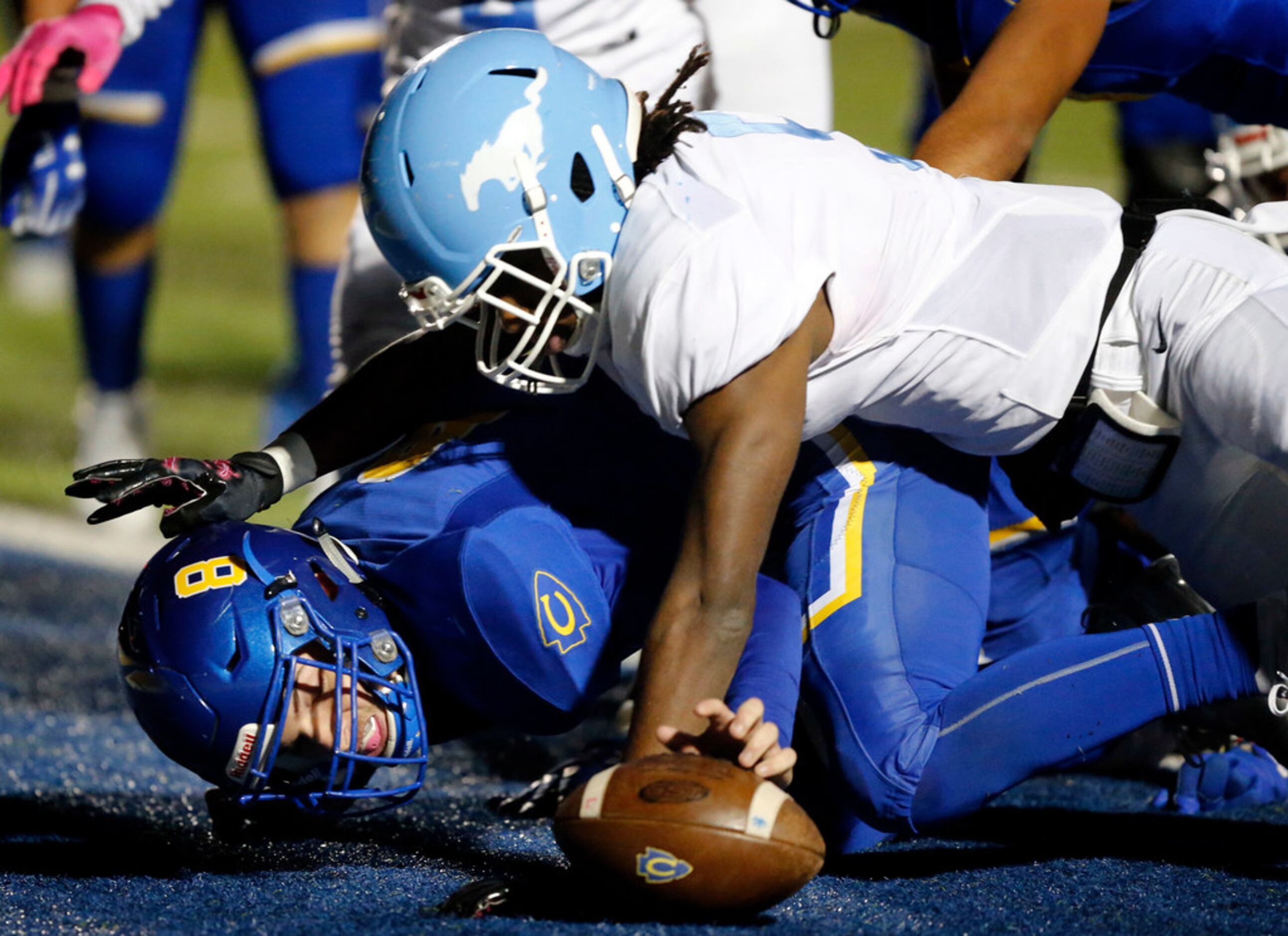 Community High quarterback Parker Simpson (8) recovers a fumble in the end zone for a...