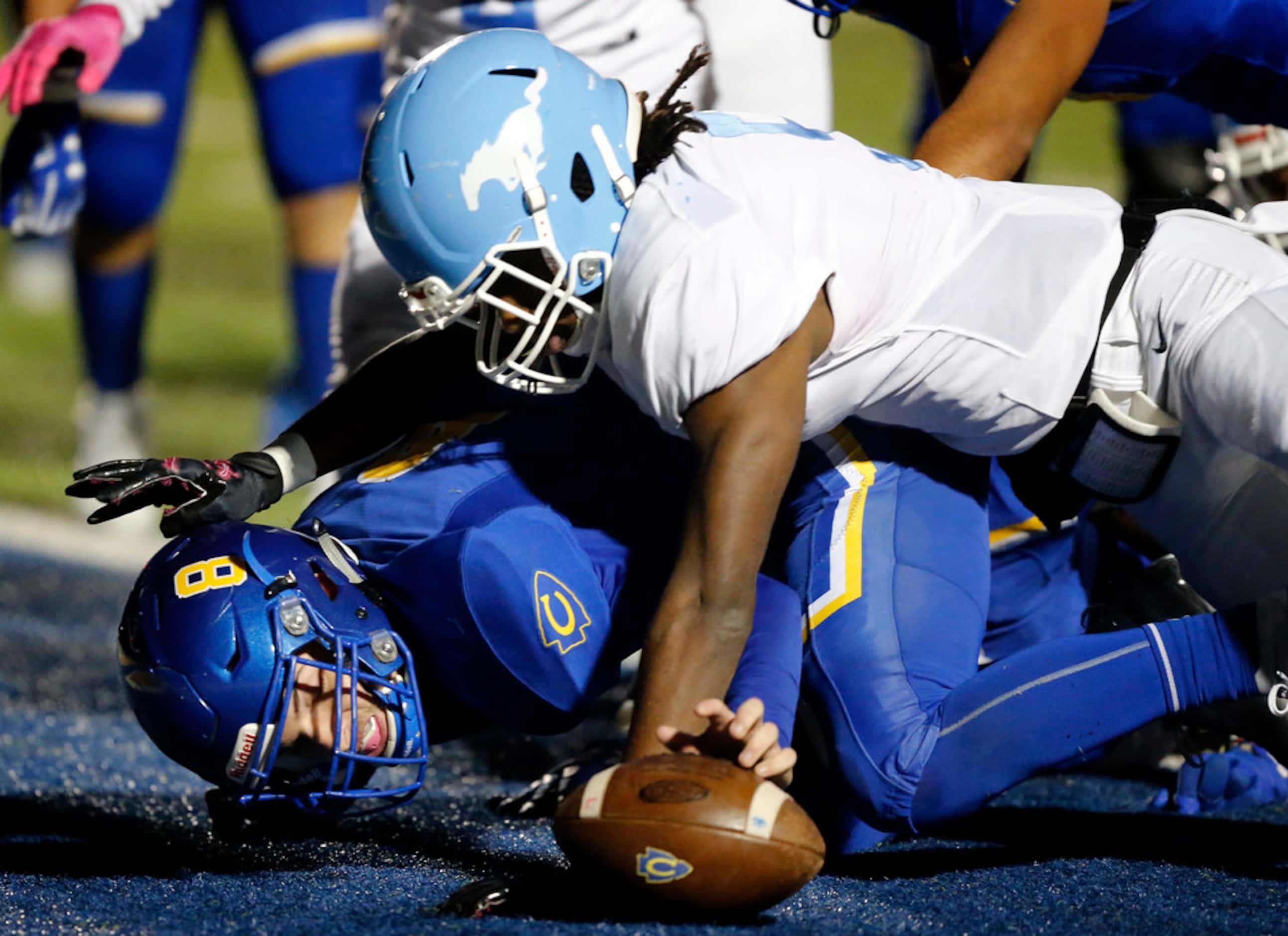 Community High quarterback Parker Simpson (8) recovers a fumble in the end zone for a...
