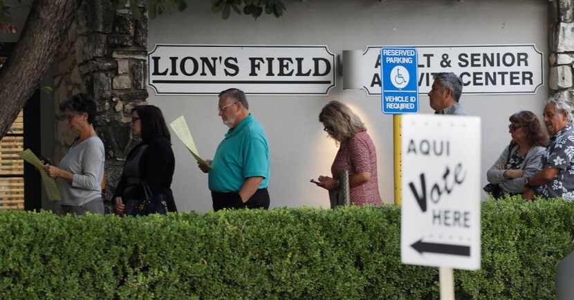 Voters stand in line at an early polling site, Monday, Oct. 24, 2016, in San Antonio.  (AP...