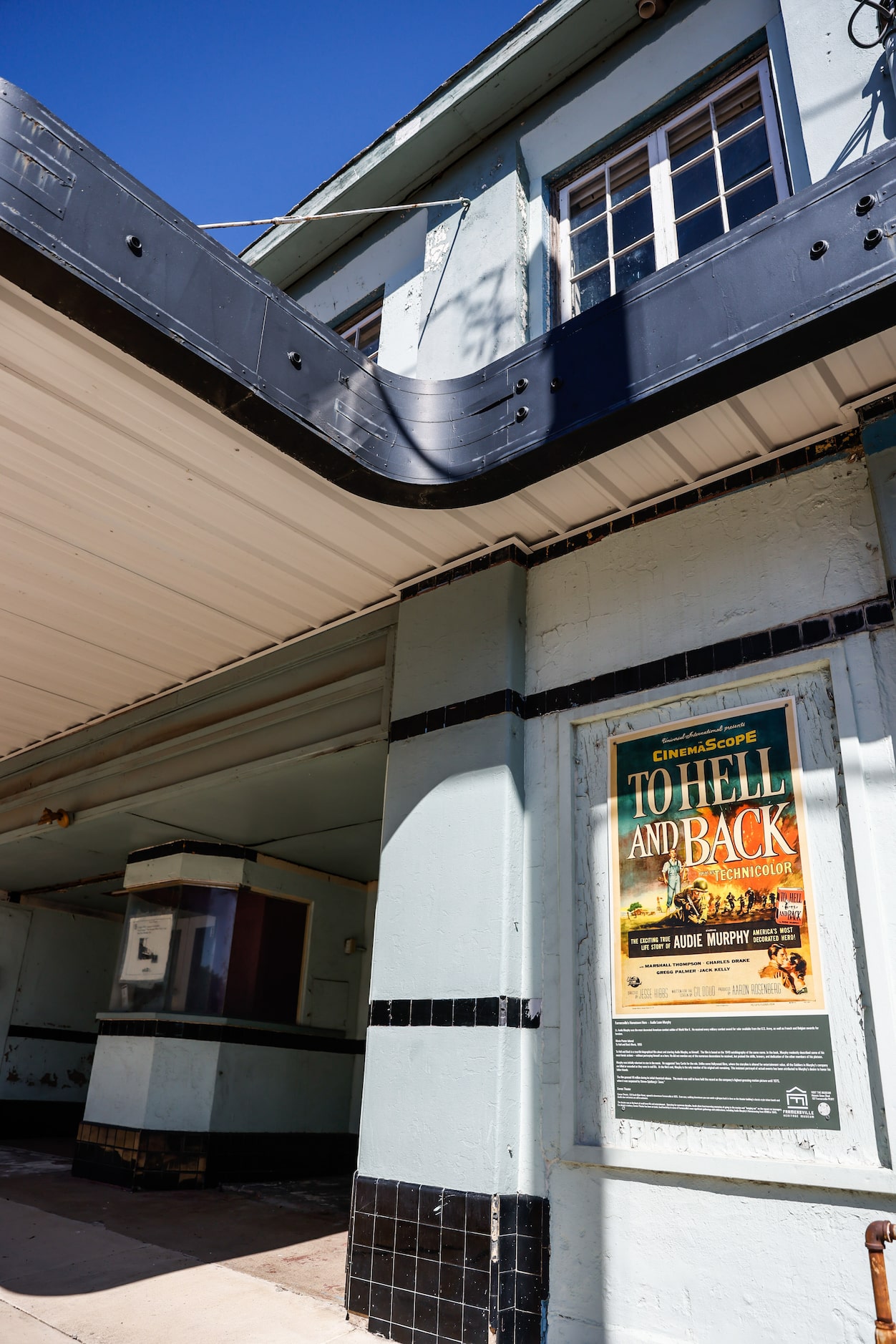 An old movie theater displays an Audie Murphy movie poster in downtown Farmersville.