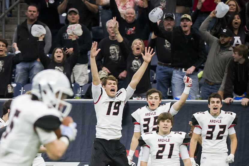 The Argyle bench erupts as wide receiver Gage McCook (5) races for a touchdown during the...