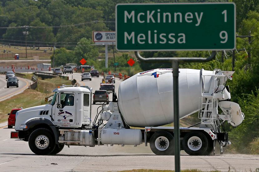 A concrete mixer truck leaves the Cow Town Redi Mix concrete plant in McKinney, Texas, ...