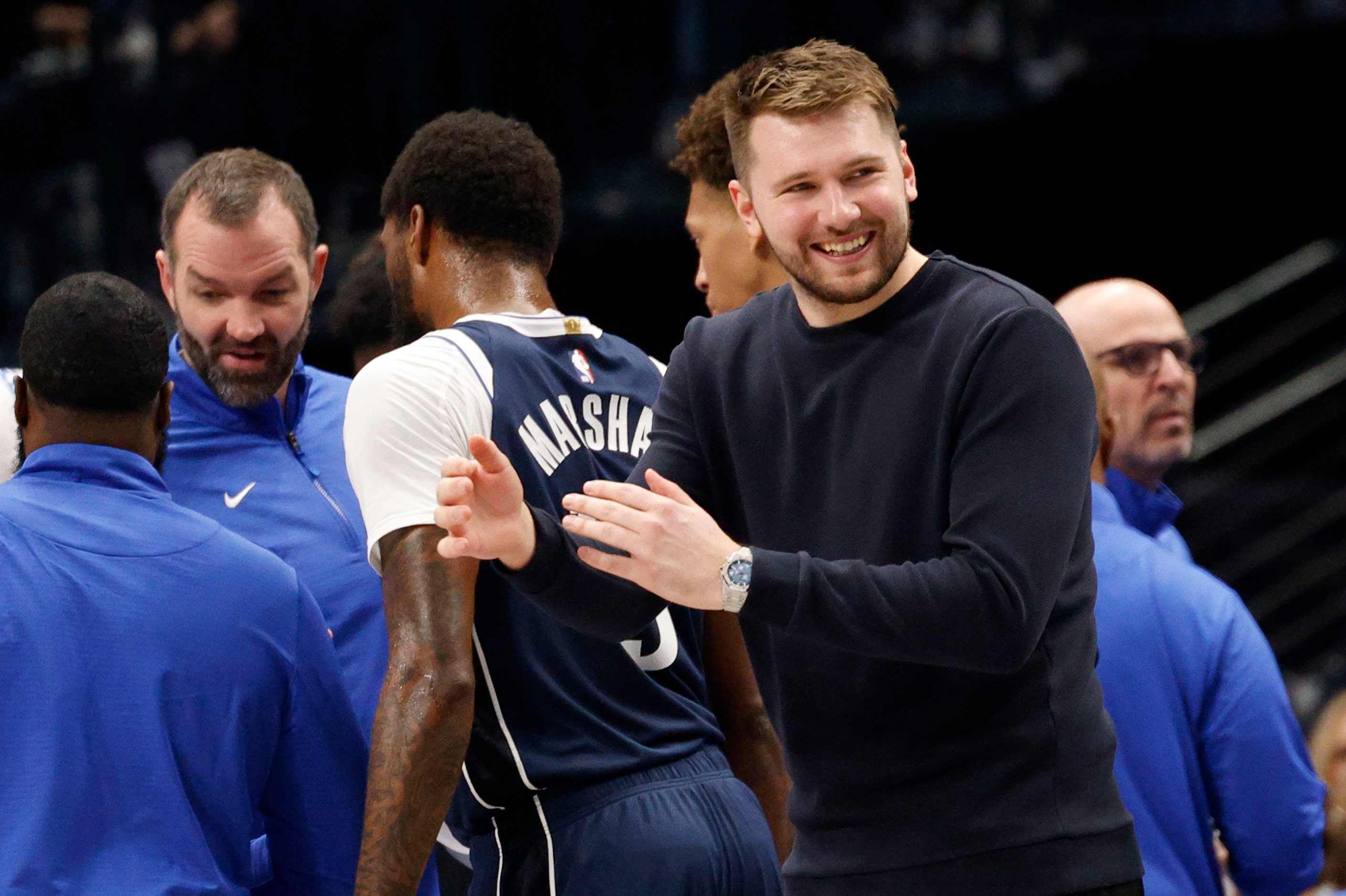 Dallas Mavericks guard Luka Doncic (77) smiles during a timeout in the first half of an NBA...