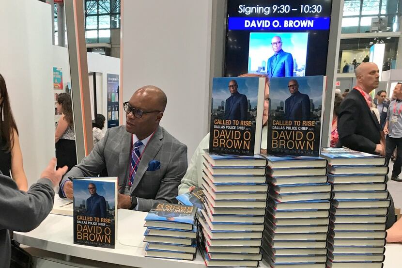 Former Dallas Police Chief David Brown signs his memoir June 1, 2017 at Book Expo in New York.
