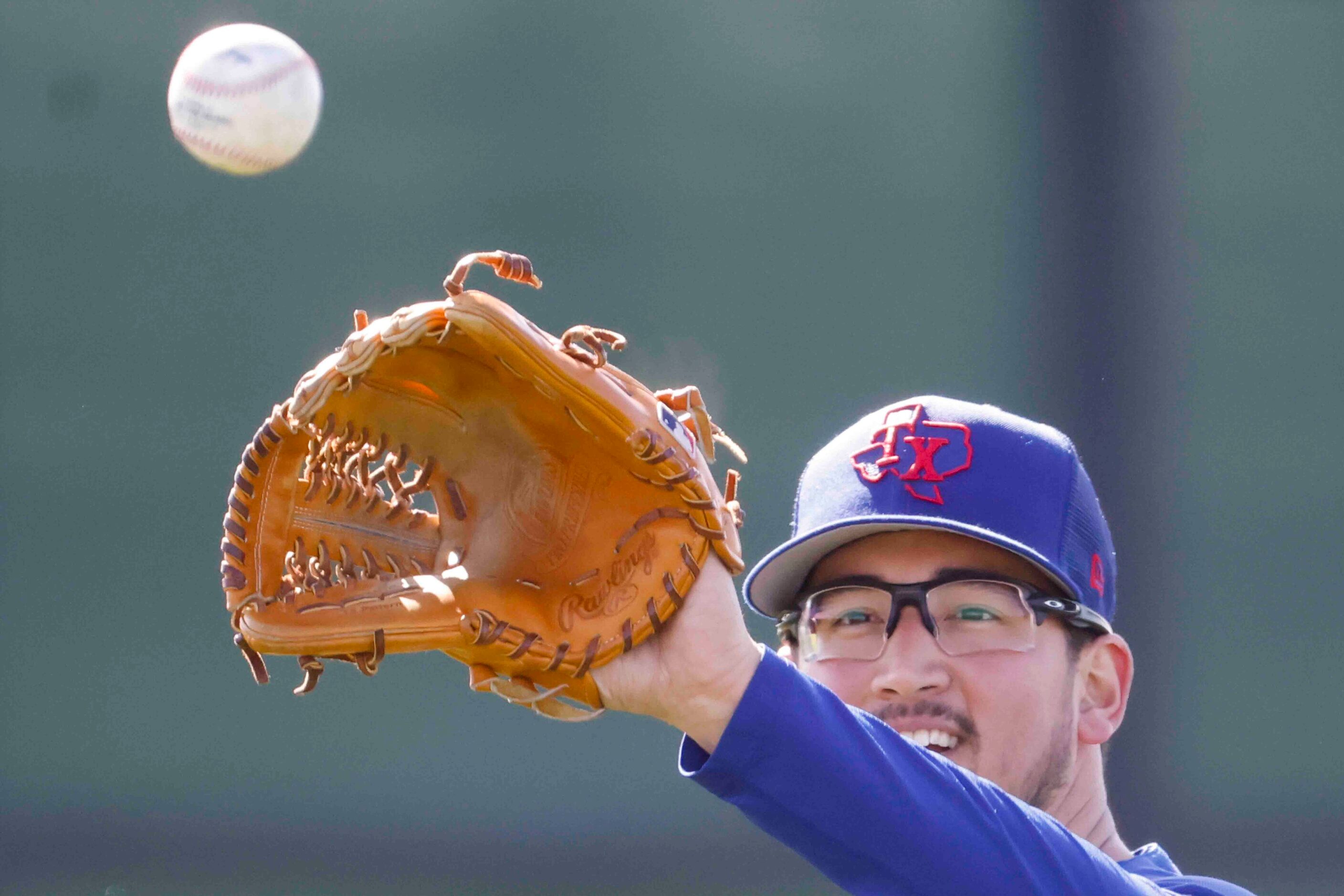 Texas Rangers right handed pitcher Dane Dunning, warms up before pitching practice during a...