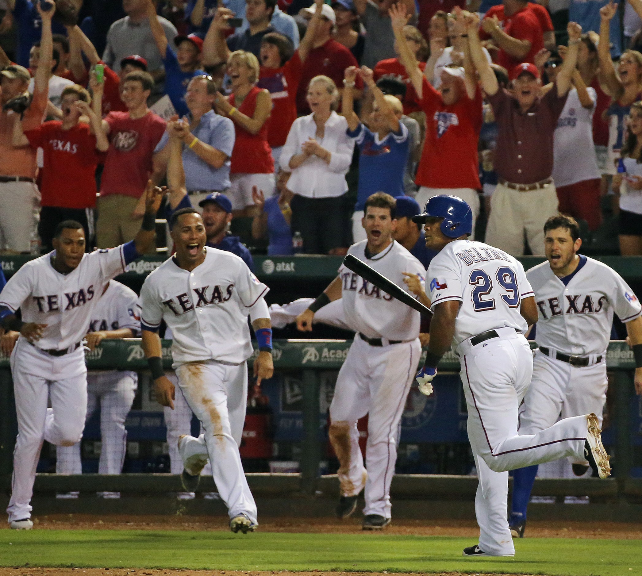 Rangers teammates celebrate Adrian Beltre's walk-off home run against the Angels. (Louis...