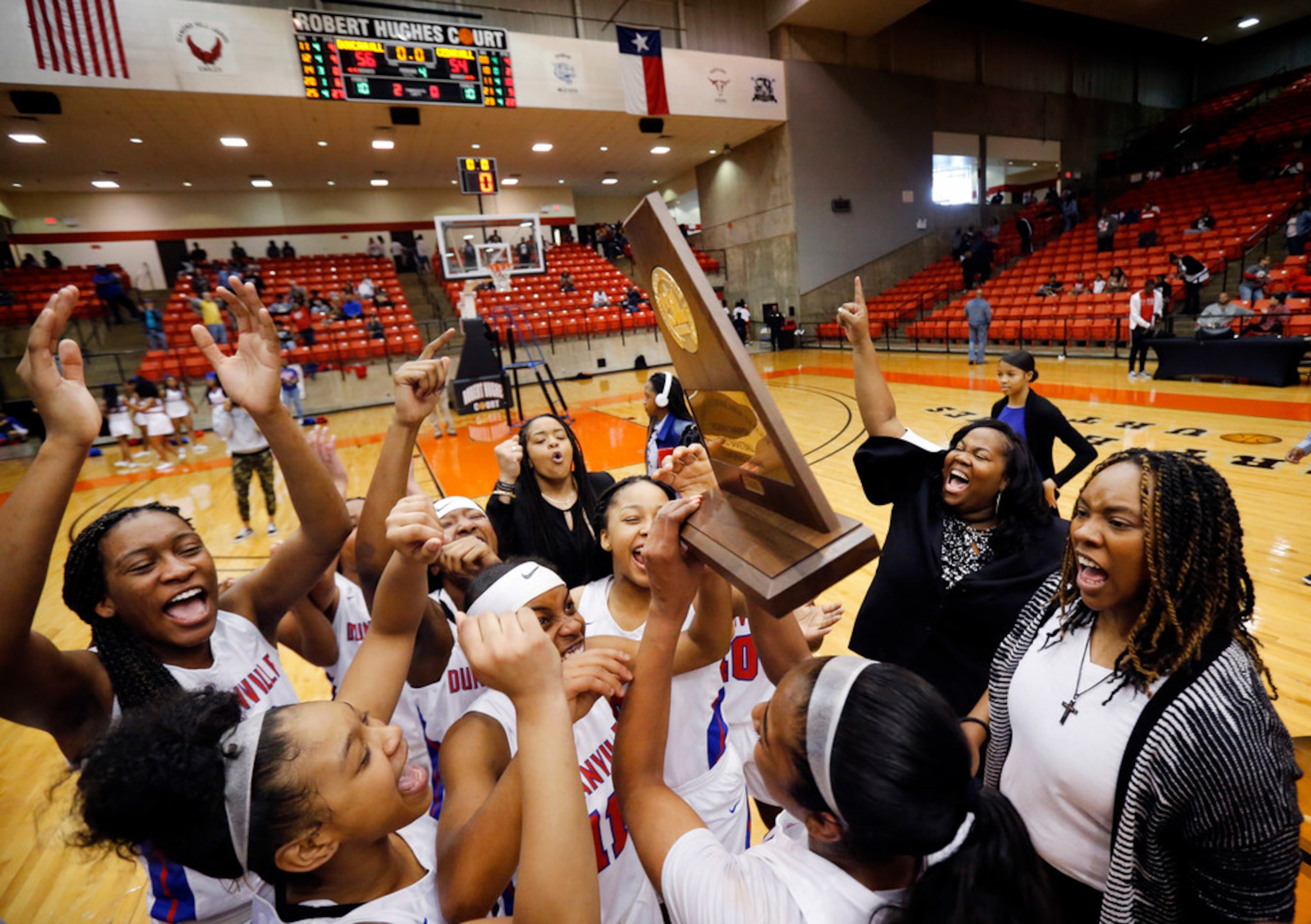 Duncanville's head coach Lajeanna Howard (right) and her players celebrate their Class 6A...