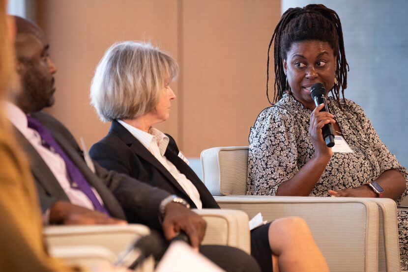 Joli Angel Robinson, far-right, of Housing Forward, answers a question during a panel titled...