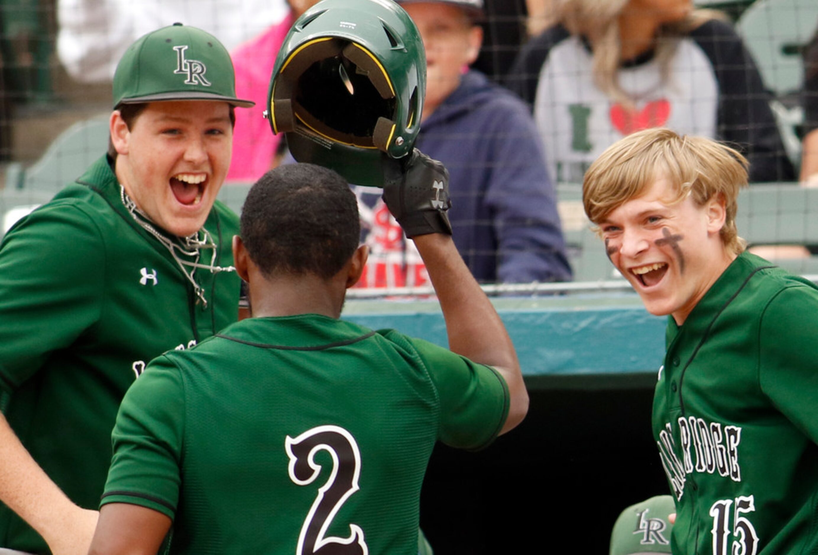 Mansfield Lake Ridge infielder MJ Sterling (2) is congratulated by teammates Jason Davis...