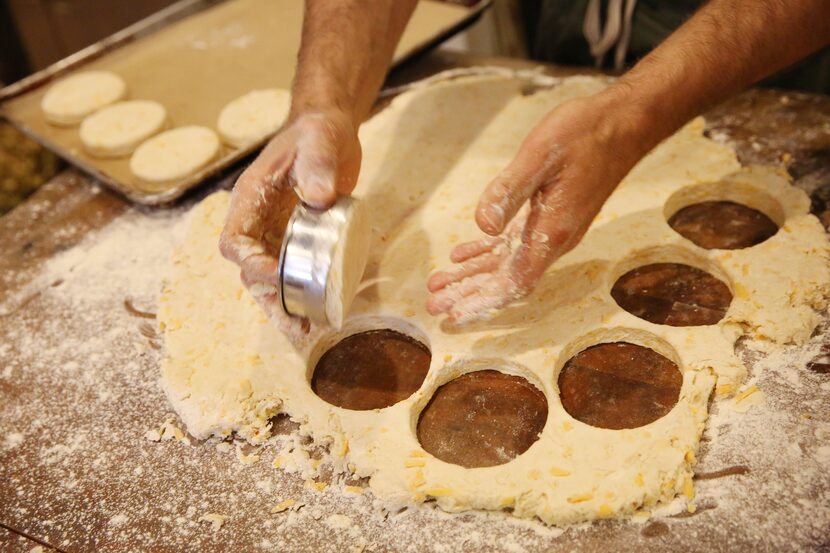 Chef Robert Lyford prepares cheddar biscuits at Patina Green Home and Market in McKinney.